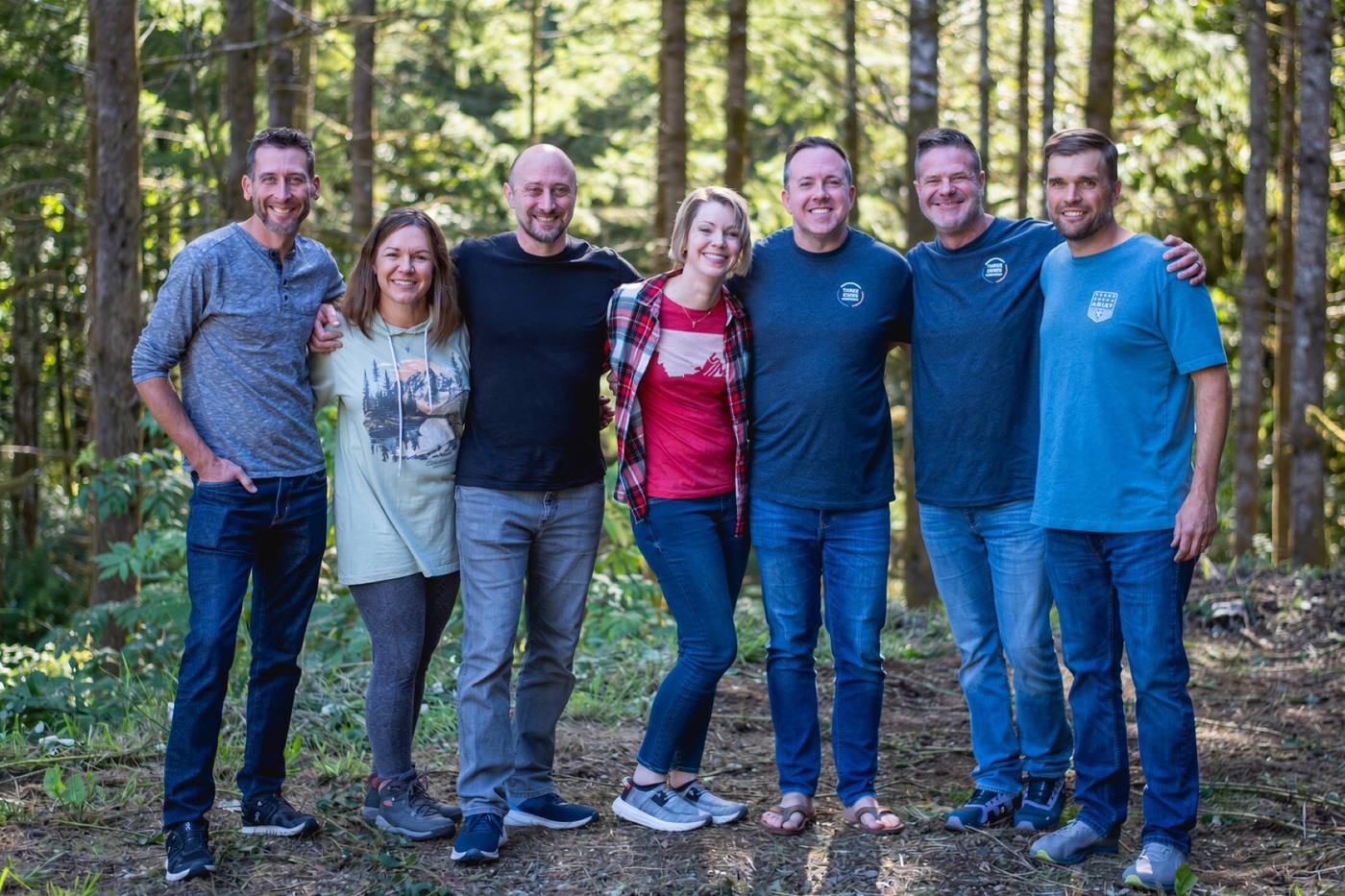 The 2026 retreat group together among the tall trees